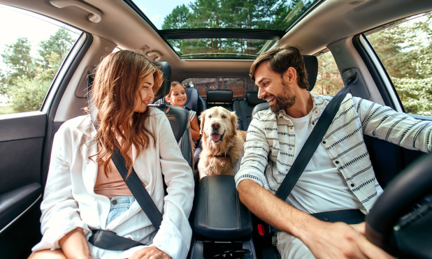 Family and Pet Enjoying Safe Trip with Onust Warranty Parents, child, and dog riding together with Onust extended auto protection